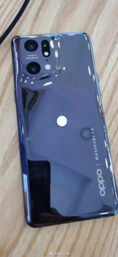 Oppo Find X5 Pro poses for camera with reflective back